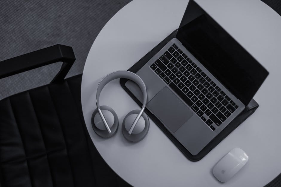 Laptop and studio headphones on a clean desk