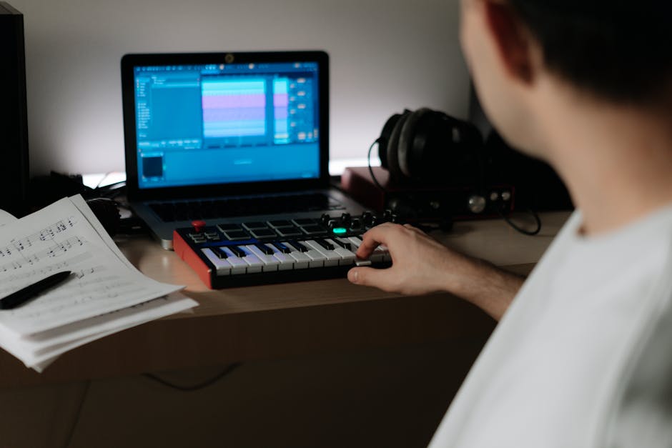 Confident music producer at a laptop in a creative session