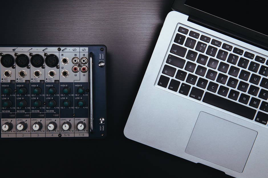 Two people in a one-on-one music production session at a desk