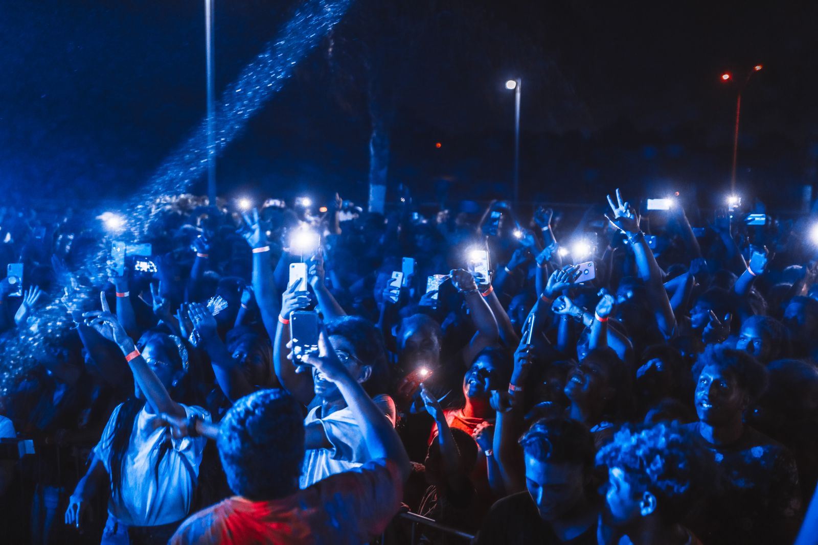 Concert crowd with phones lit up, the listeners a music ad is meant to reach